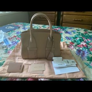 Miu Miu leather handbag with straps, brand-new.